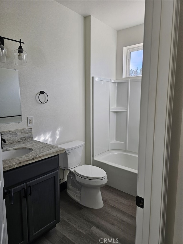 full bathroom featuring vanity, toilet, wood-type flooring, and  shower combination