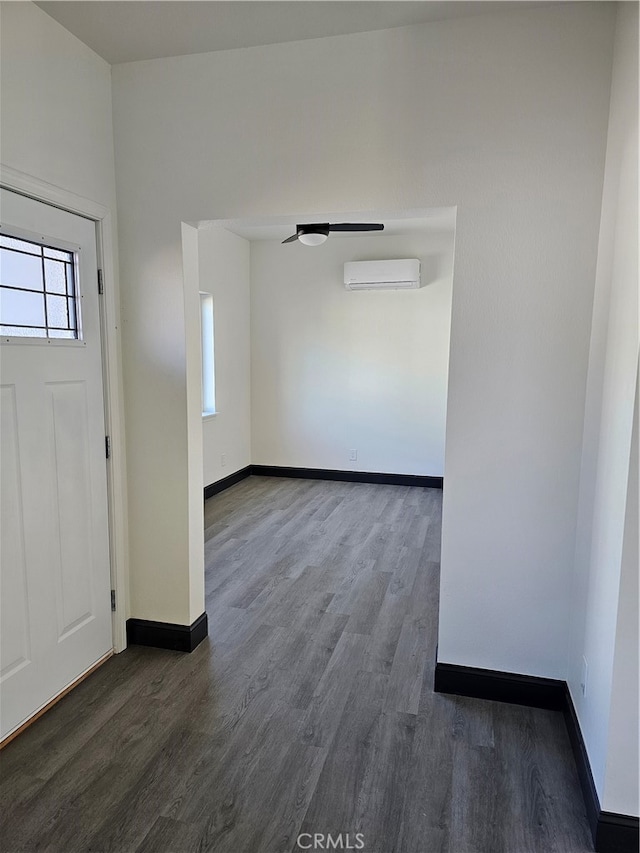 foyer entrance with dark hardwood / wood-style flooring and a wall mounted air conditioner