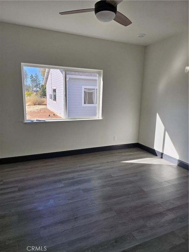 unfurnished room featuring dark hardwood / wood-style floors and ceiling fan