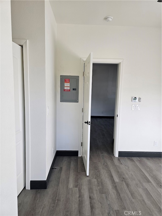 hall with dark wood-type flooring and electric panel