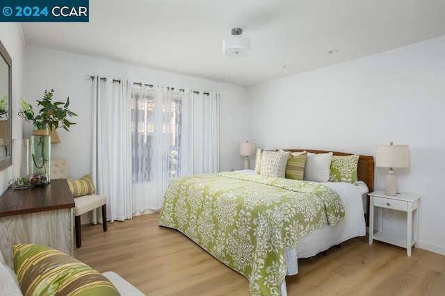 bedroom with light hardwood / wood-style flooring