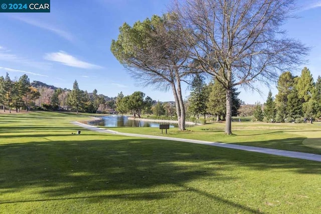 view of community featuring a yard and a water view