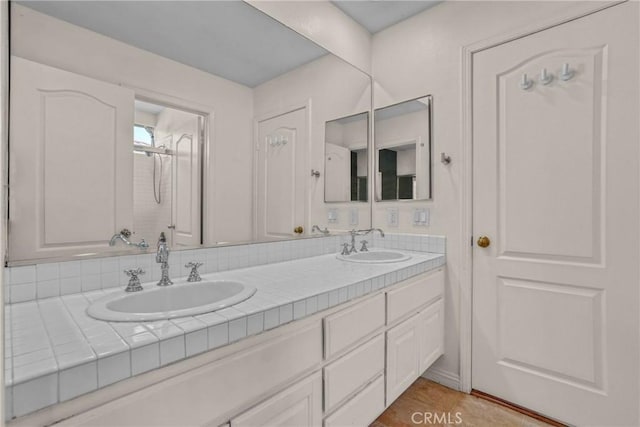 bathroom featuring double vanity, a sink, and tile patterned floors