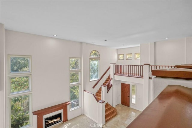 interior space featuring recessed lighting and a glass covered fireplace