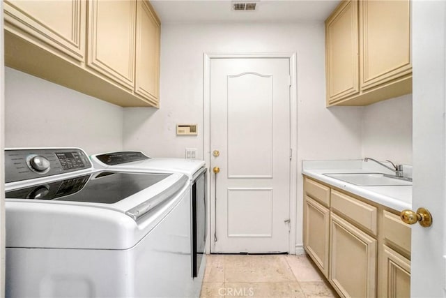 clothes washing area with cabinet space, visible vents, independent washer and dryer, a sink, and light tile patterned flooring