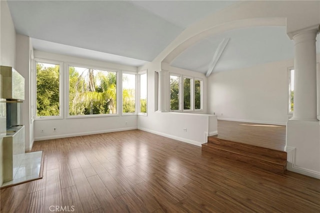 interior space with vaulted ceiling and decorative columns