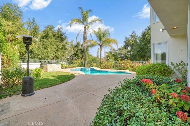 view of swimming pool with a patio area, fence, and a fenced in pool