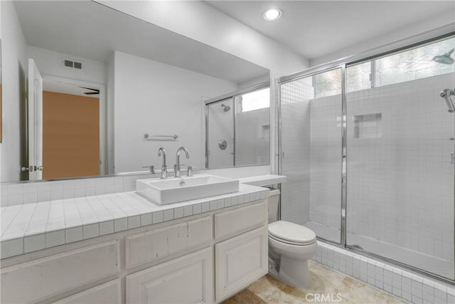 full bath featuring visible vents, toilet, vanity, a shower stall, and recessed lighting