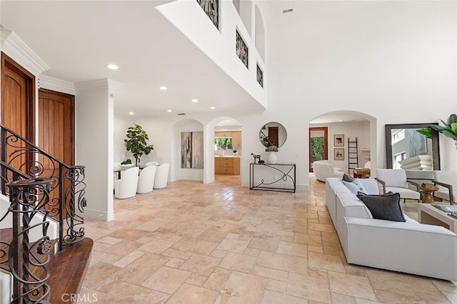 foyer entrance featuring ornamental molding and a high ceiling