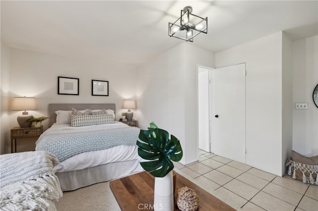 bedroom featuring an inviting chandelier and light tile patterned floors