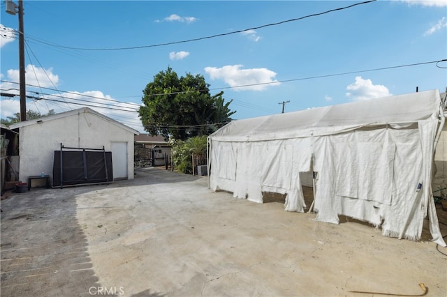 view of patio / terrace with a shed