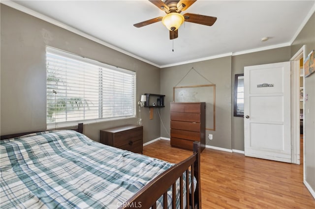 bedroom featuring ceiling fan, crown molding, and light wood-type flooring