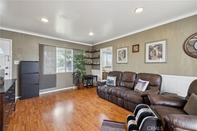 living room featuring light hardwood / wood-style floors and ornamental molding