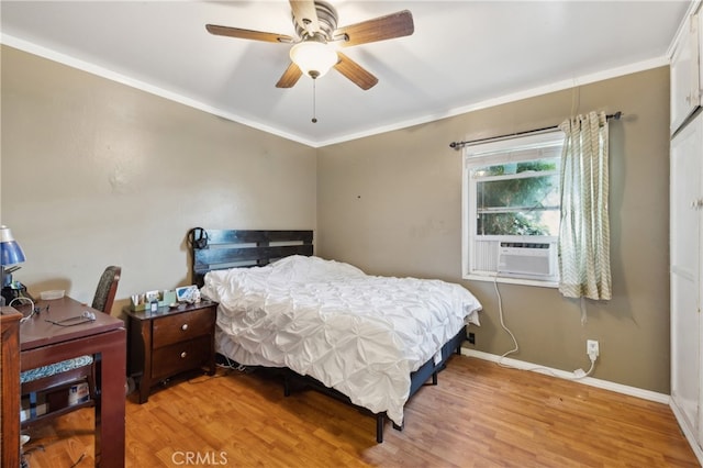 bedroom with hardwood / wood-style floors, cooling unit, crown molding, and ceiling fan