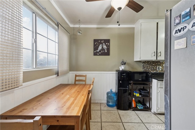 dining space featuring ornamental molding, a healthy amount of sunlight, ceiling fan, and light tile patterned floors