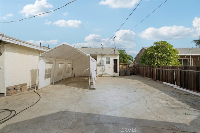 rear view of house with a patio area and a carport