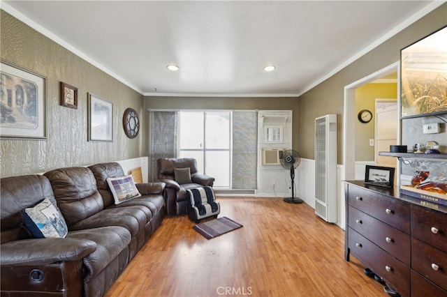 living room with ornamental molding and light wood-type flooring