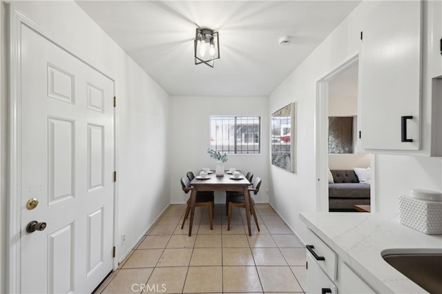 dining space with sink and light tile patterned floors