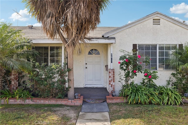 entrance to property with a yard