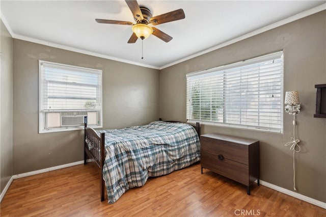 bedroom with light hardwood / wood-style flooring, multiple windows, and ceiling fan