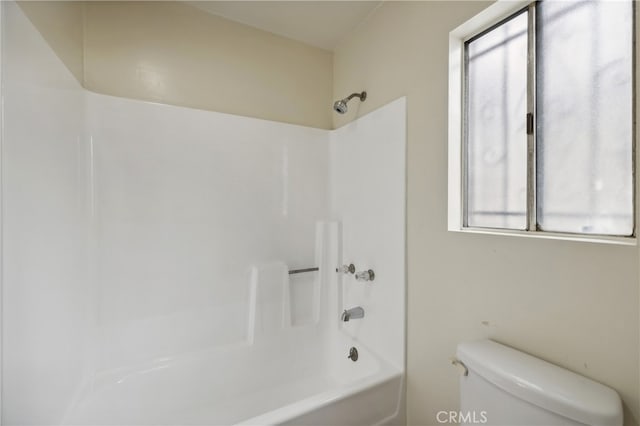 bathroom with shower / washtub combination and toilet