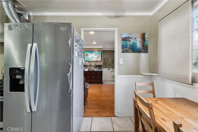 kitchen with light tile patterned flooring and stainless steel fridge