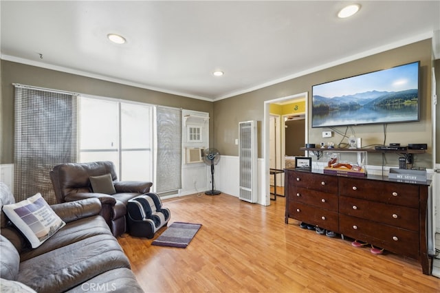 living room with crown molding and light hardwood / wood-style flooring