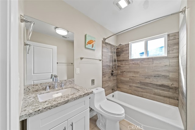 full bathroom with vanity, tiled shower / bath combo, toilet, and tile patterned flooring