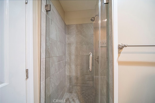 bathroom with a shower with door