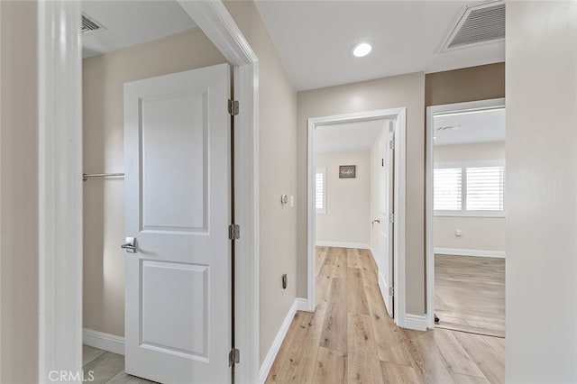 hallway with light hardwood / wood-style flooring