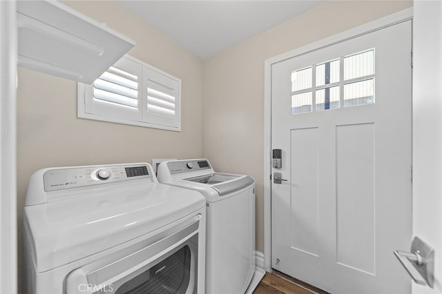 laundry room featuring separate washer and dryer and dark hardwood / wood-style flooring