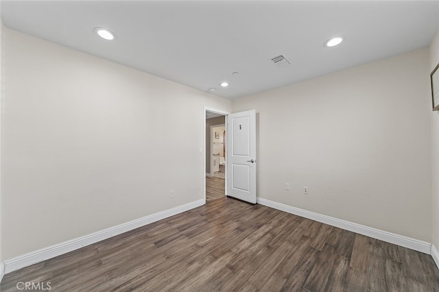 spare room featuring dark wood-type flooring