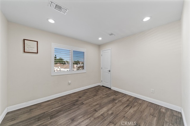 empty room featuring dark hardwood / wood-style flooring