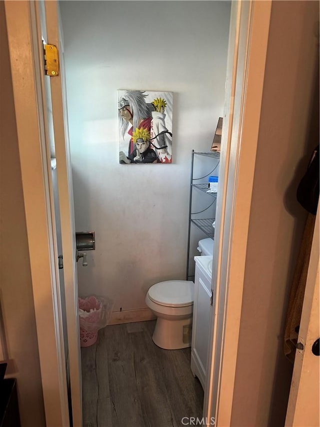 bathroom with hardwood / wood-style flooring, vanity, and toilet