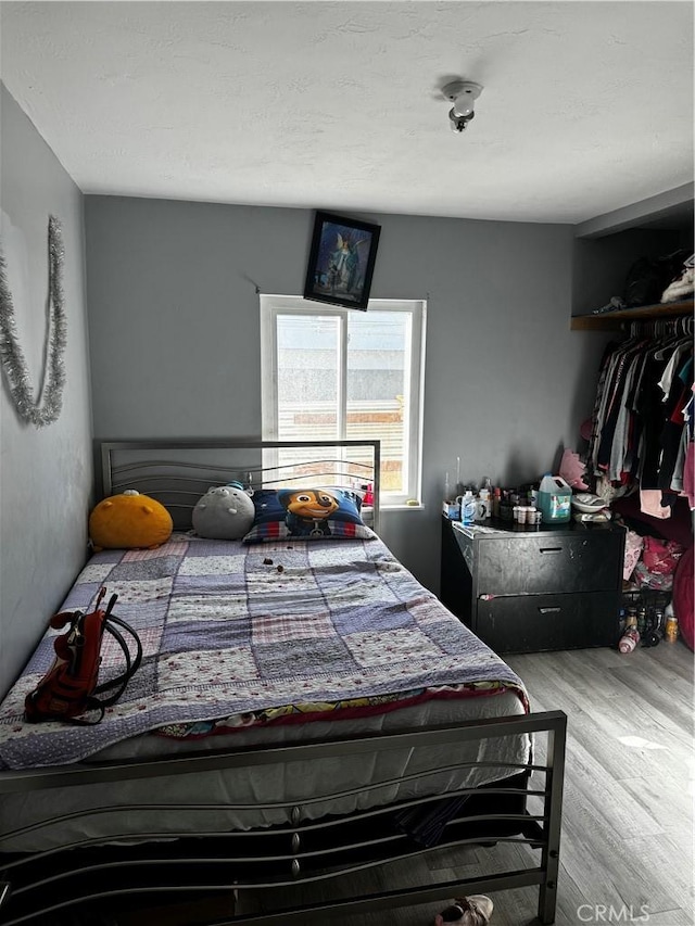 bedroom with hardwood / wood-style floors