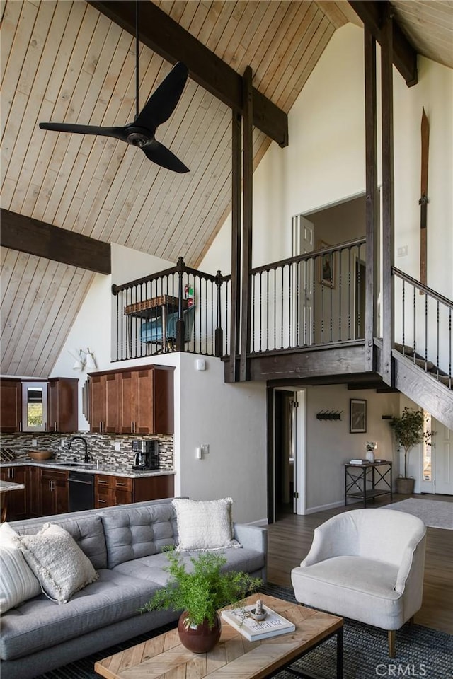 living room featuring high vaulted ceiling, sink, ceiling fan, beam ceiling, and wood-type flooring