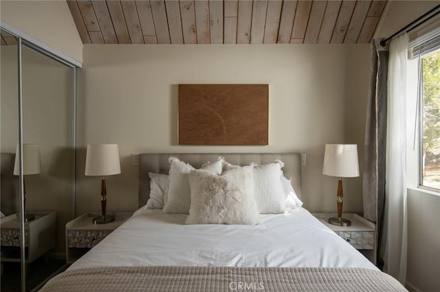 bedroom with a closet, wooden ceiling, and vaulted ceiling