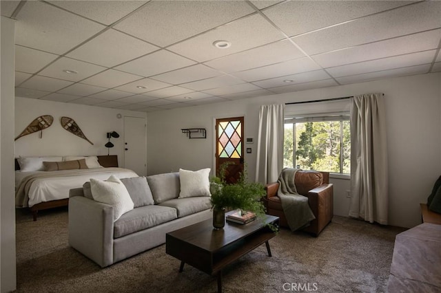 bedroom with a paneled ceiling and carpet