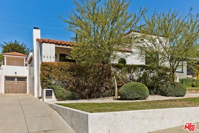 mediterranean / spanish house with a garage