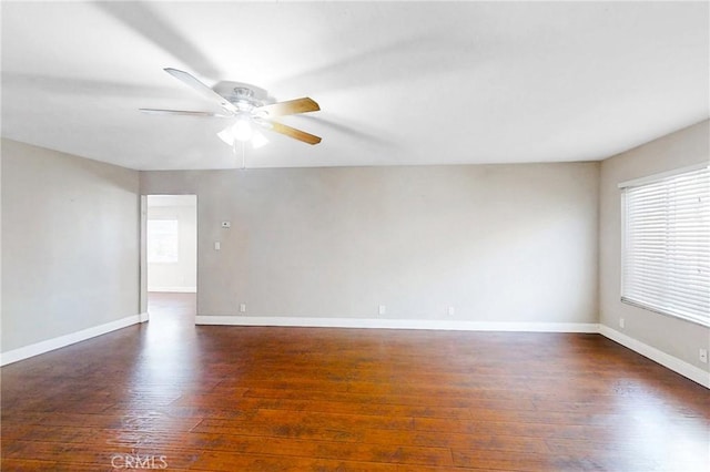 spare room with dark hardwood / wood-style floors and ceiling fan