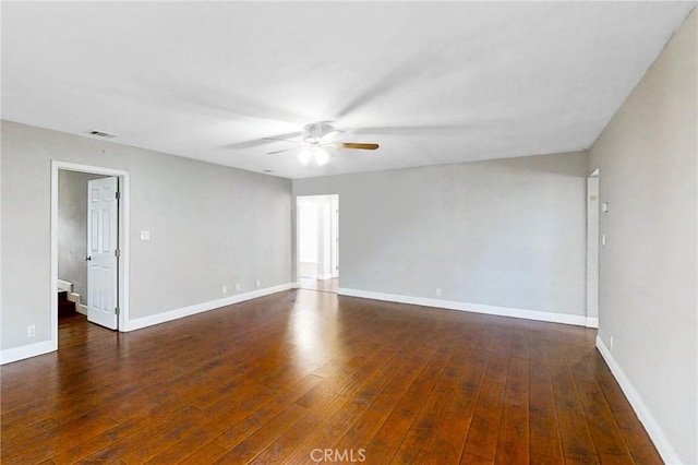 spare room featuring ceiling fan and dark hardwood / wood-style floors