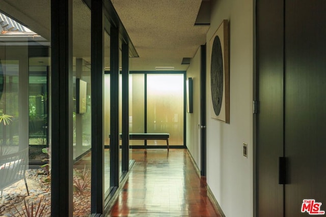 hallway with a textured ceiling