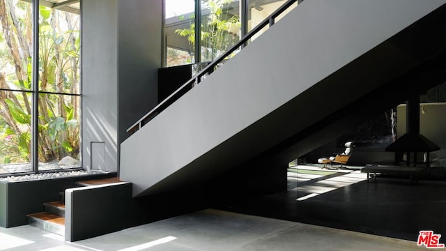 stairway featuring concrete flooring