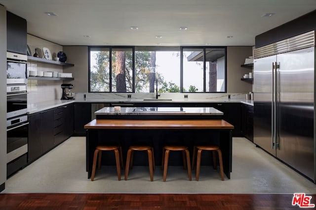 kitchen featuring a breakfast bar, a kitchen island, and stainless steel appliances