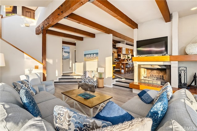 living room with light hardwood / wood-style flooring and beamed ceiling