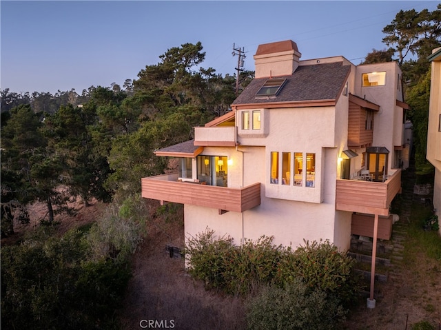 back of house featuring a balcony