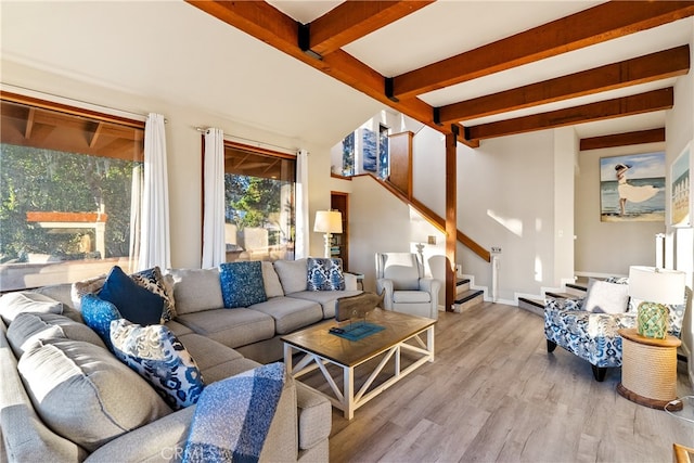 living room with beamed ceiling and light hardwood / wood-style flooring