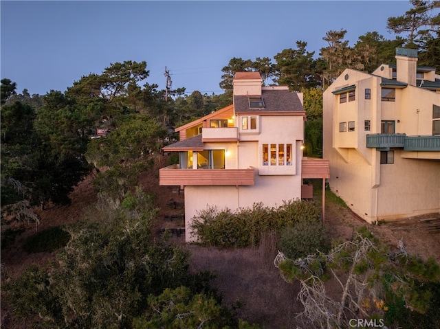 rear view of property with a balcony