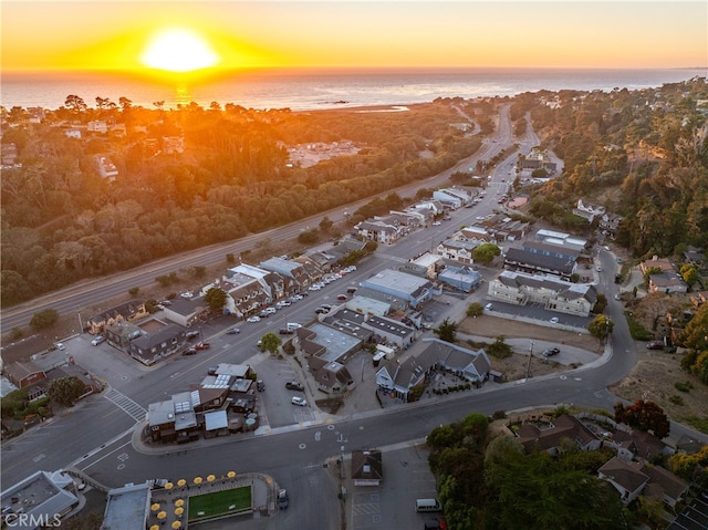 aerial view at dusk with a water view