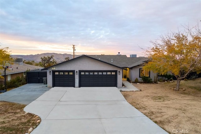 view of front of home with a mountain view and a garage